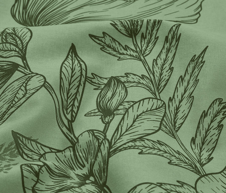 Gros plan d'un tissu vert clair avec un imprimé floral vert foncé.