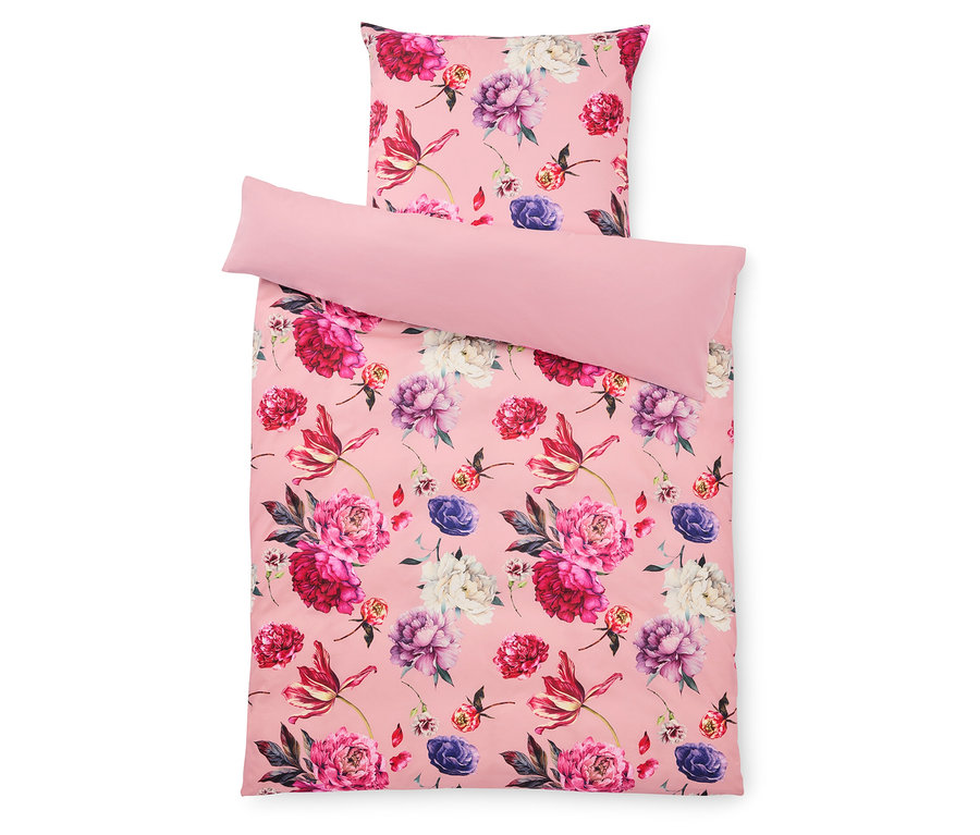 Ensemble de literie rose à motifs floraux avec oreiller et housse.