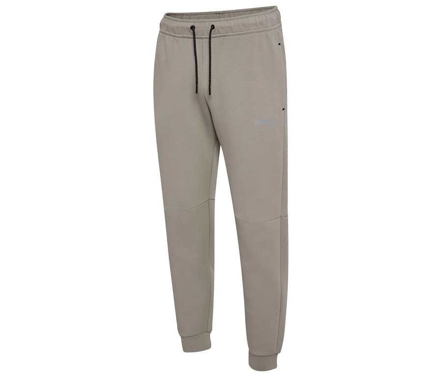 Gros plan sur un pantalon de jogging HUMMEL beige pour homme avec cordon de serrage et poignets.