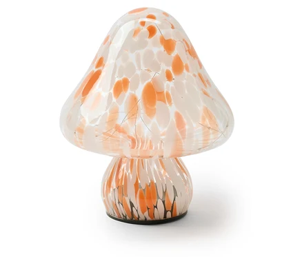 Lampe en verre en forme de champignon avec des taches orange et blanches et un éclairage intérieur.