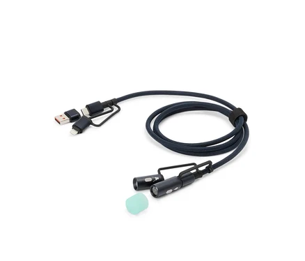 Un câble de charge bleu avec des connecteurs USB, USB-C et Lightning, ainsi que deux petites lumières LED et un embout en silicone, est posé sur un fond blanc.