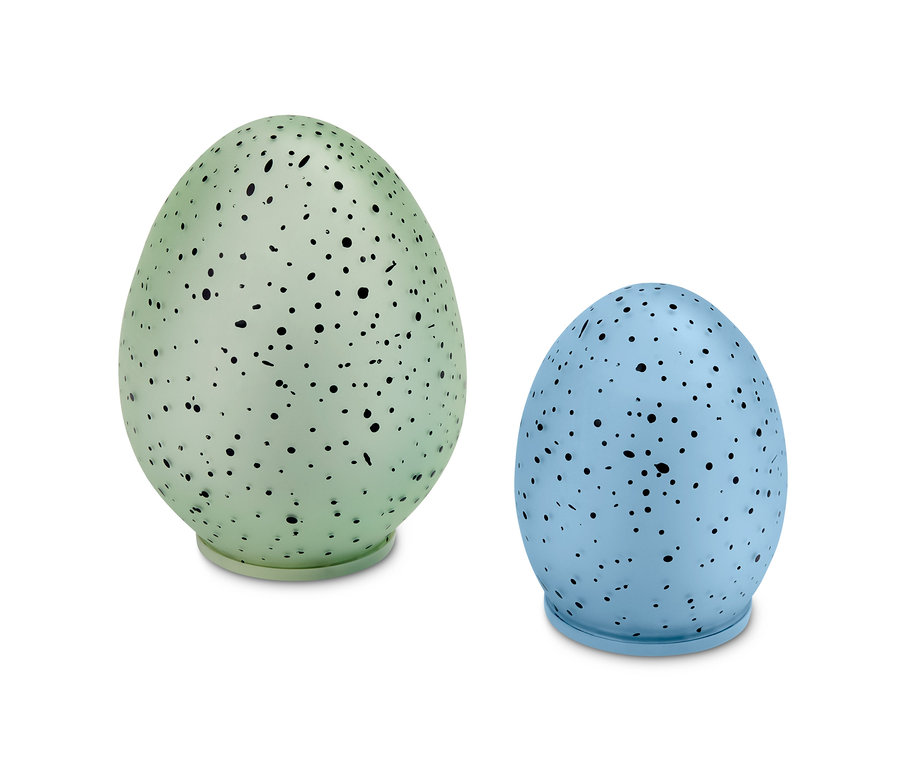 Deux œufs décoratifs à LED, un vert et un bleu, avec des taches noires.