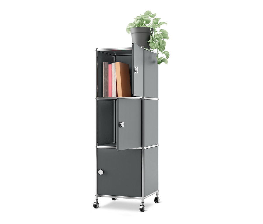 Caisson en métal à roulettes « CN3 » gris avec 3 portes, des livres dans un compartiment ouvert et une plante en pot sur le dessus. Deux portes sont légèrement entrouvertes.