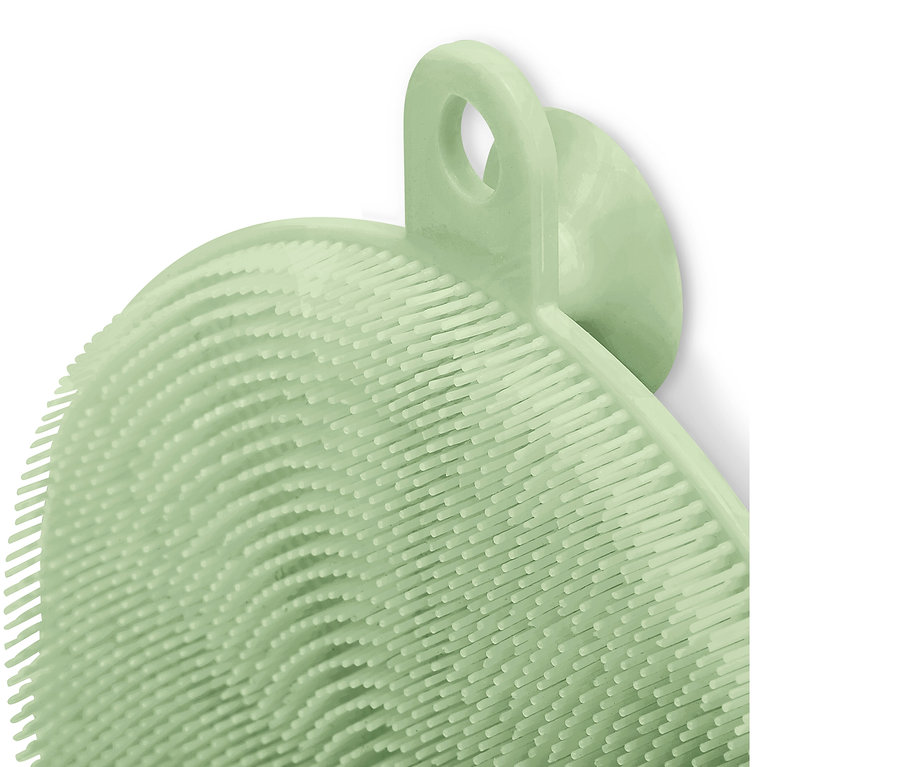 Gros plan d'une éponge de nettoyage en silicone vert clair.