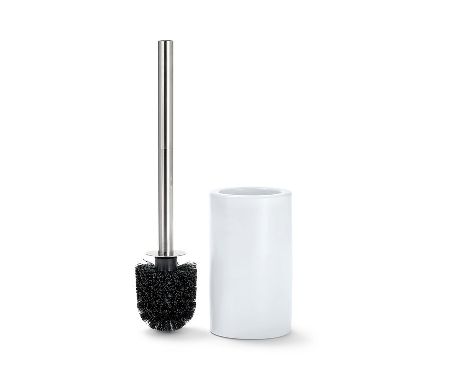 Une brosse de toilette avec un support en céramique blanche.