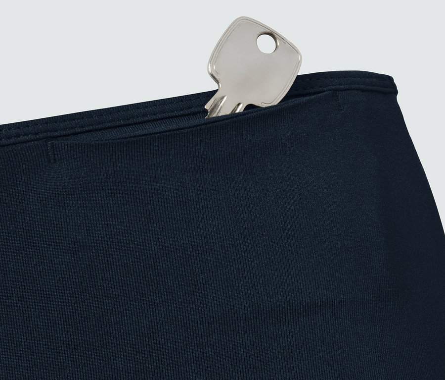 Clé dans la poche d'un legging de sport bleu marine.