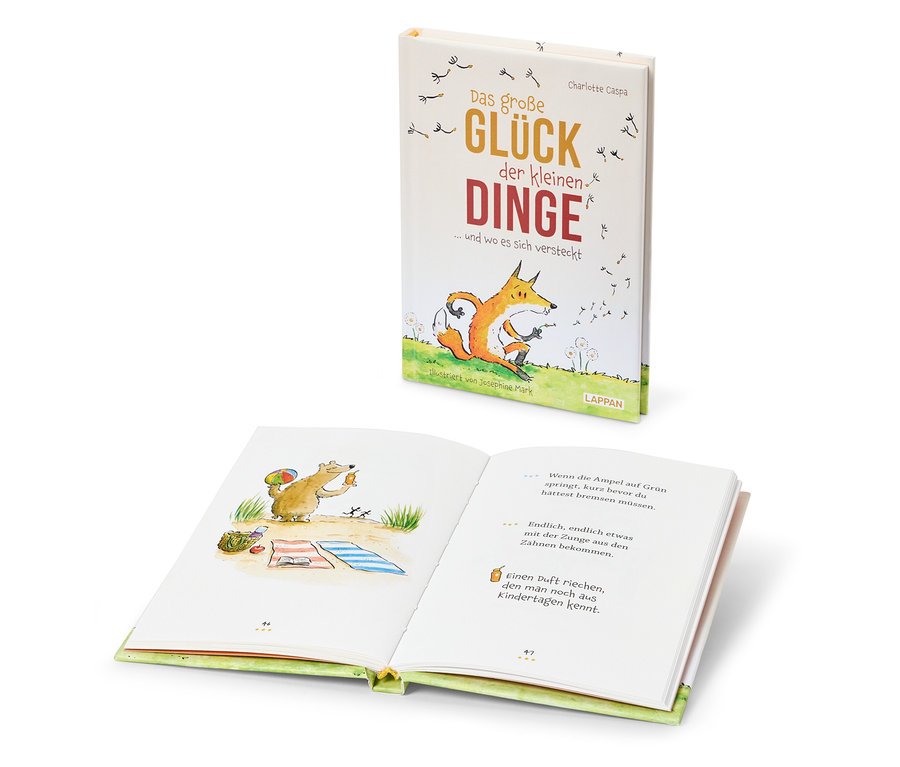 Deux livres intitulés "Das große Glück der kleinen Dinge". Sur la couverture de l'un, il y a un renard et sur les pages de l'autre, il y a un ours.