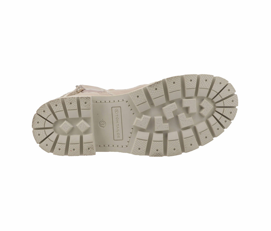 Semelle d'une botte beige avec un motif prononcé.