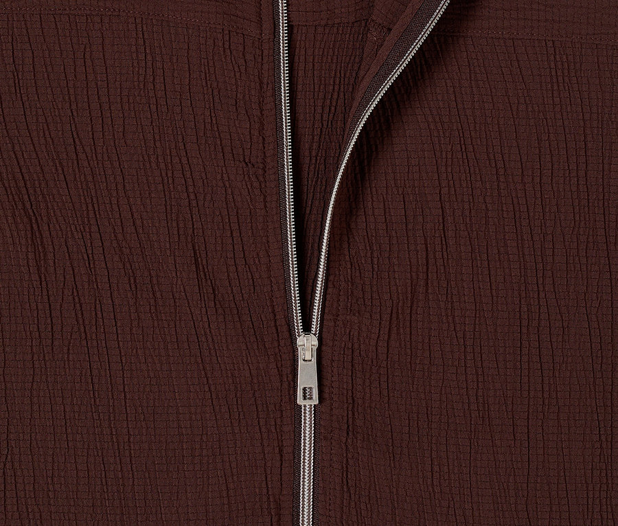 Gros plan sur le blouson CECIL marron foncé ouvert avec une fermeture éclair argentée.