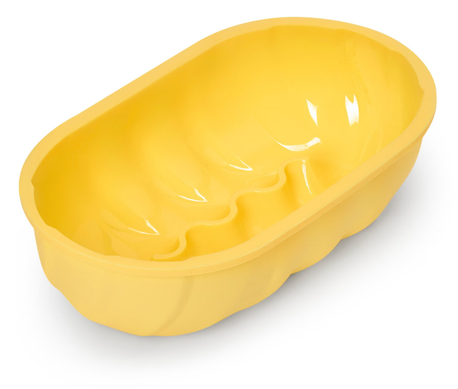 Moule à cake ovale jaune avec fond ondulé.
