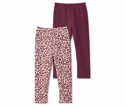 Deux leggings superposés, l'un uni bordeaux, l'autre à motif léopard beige et bordeaux.