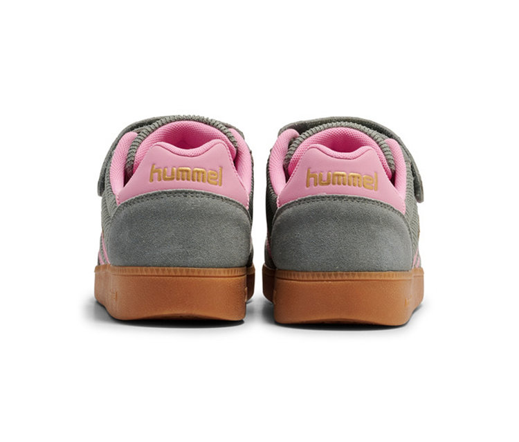 Deux baskets hummel® VM78 CPH JR, vues de dos, avec une tige grise, une doublure et des contreforts roses avec un logo hummel doré, et des semelles marron.