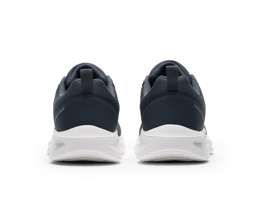 Deux chaussures de sport gris foncé à semelles blanches, vues de dos. La chaussure gauche porte l'inscription « COMFORT FOAM », la droite « COMFORT ».