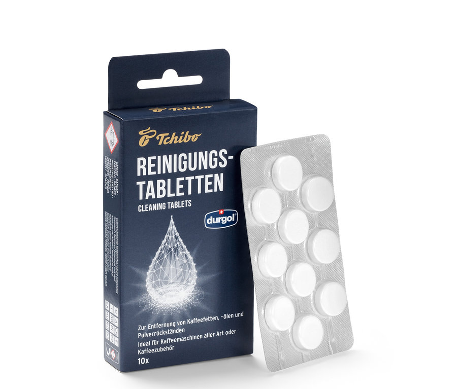 Un paquet de pastilles de nettoyage durgol® pour les huiles de café et une plaquette alvéolée de comprimés.