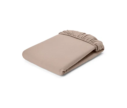 Drap-housse beige plié avec élastique.