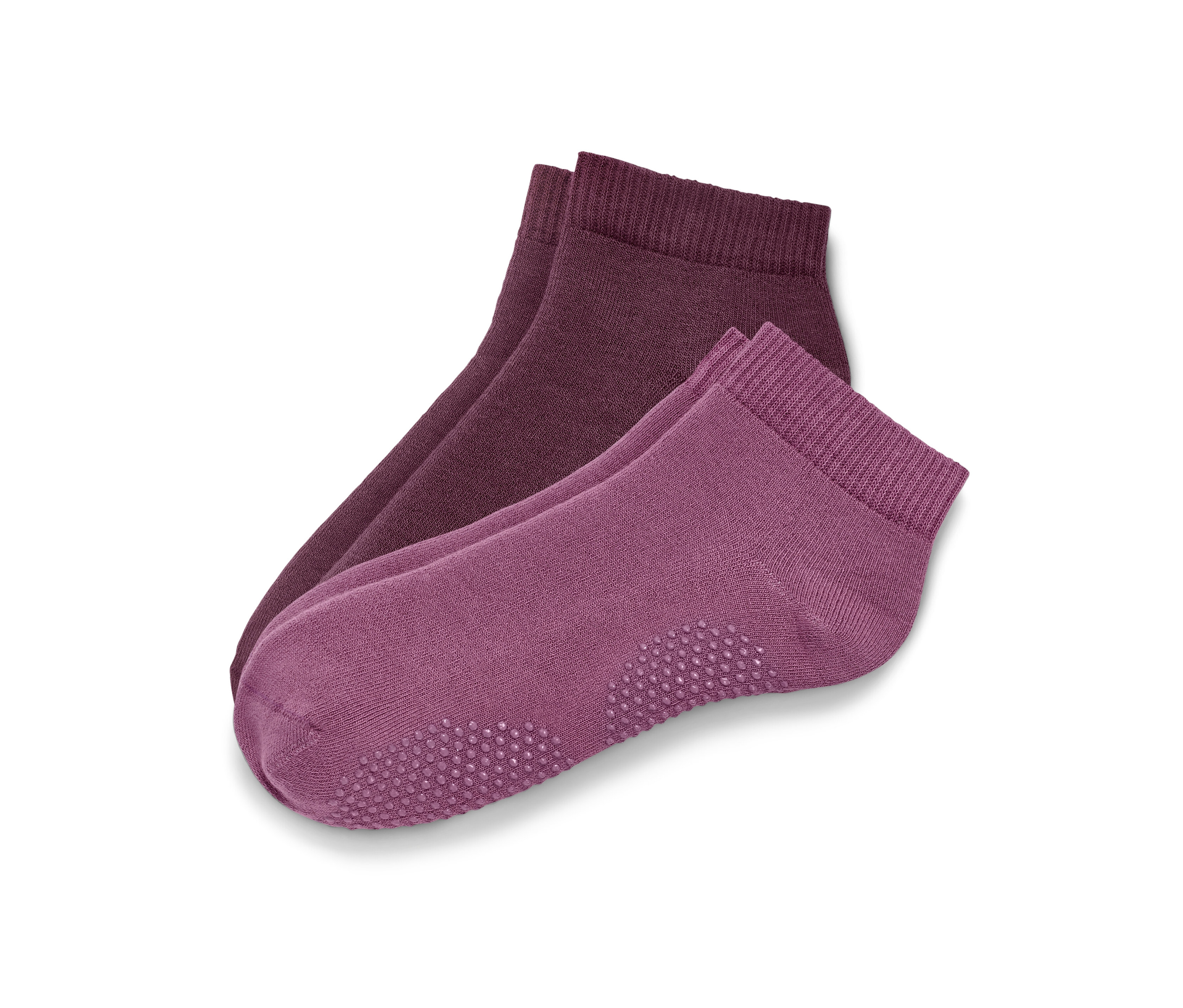 Deux paires de chaussettes de yoga rose pâle et mauve.