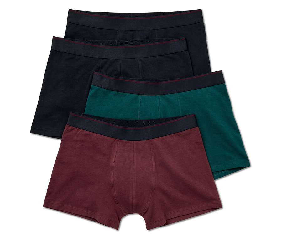 Quatre boxers pour hommes en noir, bleu marine, vert et bordeaux avec une ceinture noire.