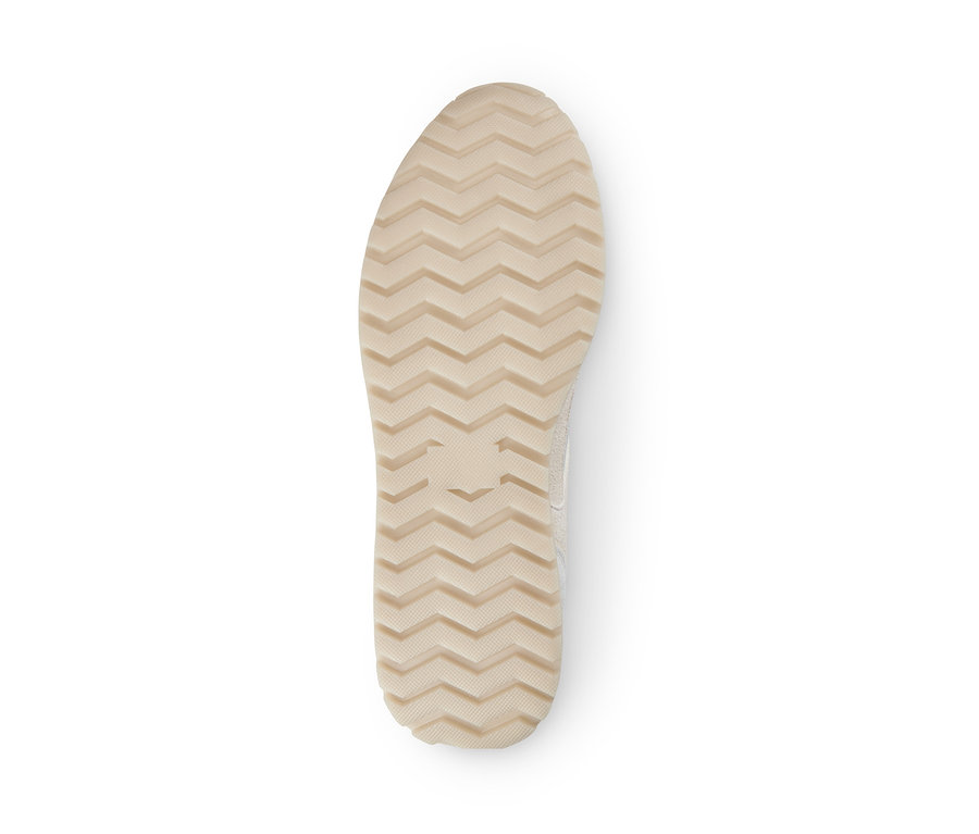 Semelle d'une basket en cuir velours avec un motif ondulé.