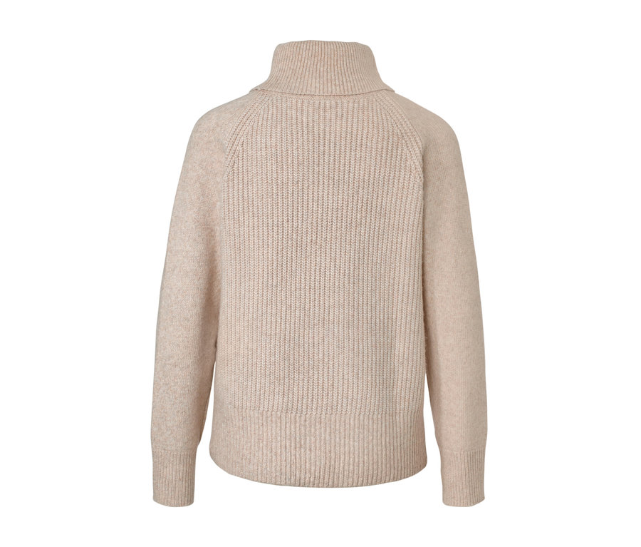 Pull à col roulé en grosse maille beige.
