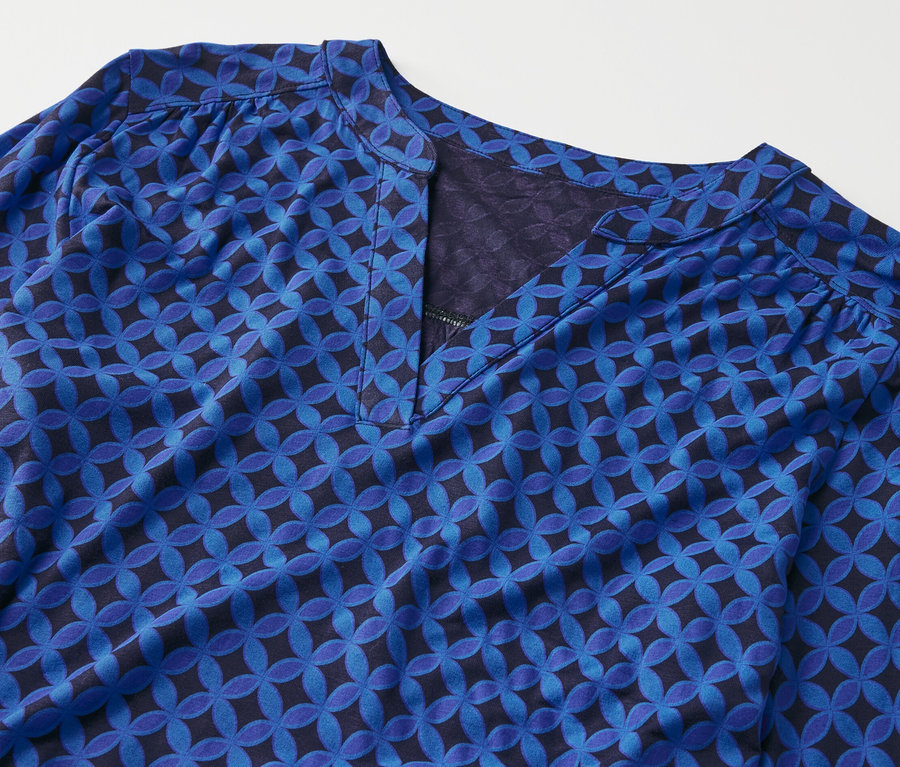 Détail d'un chemisier bleu cobalt à motifs.