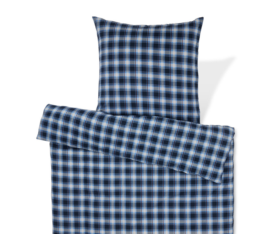 Linge de lit à carreaux bleus avec oreiller.