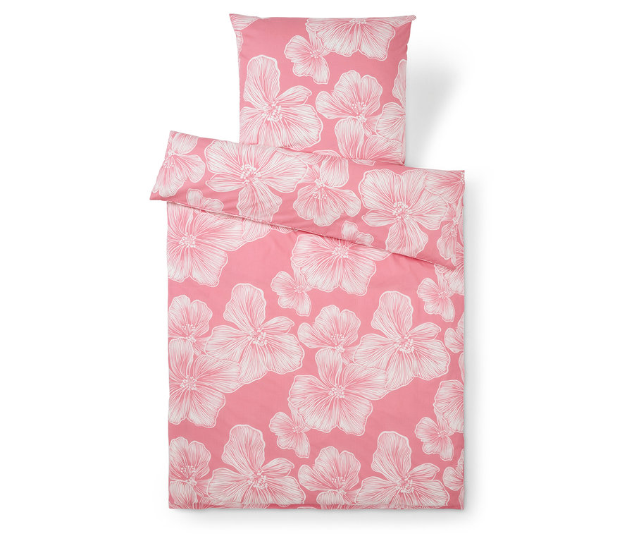 Ensemble de literie rose avec motifs floraux blancs, comprenant une taie d'oreiller.