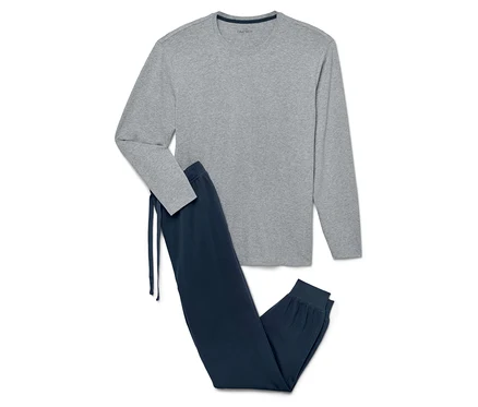 Un pyjama gris à manches longues et un pantalon de pyjama bleu marine avec cordon de serrage sont posés sur un fond blanc.