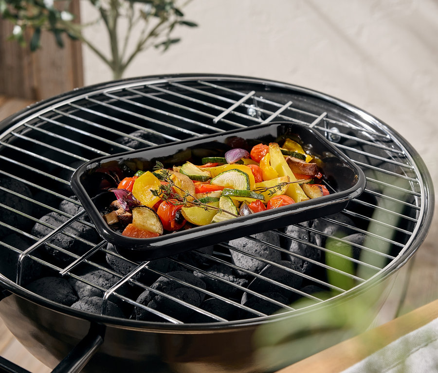 Légumes dans un plat noir sur un barbecue.