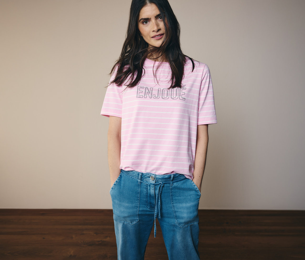 Femme portant un t-shirt rose rayé et un jeans CECIL « Neele » avec les mains dans les poches.