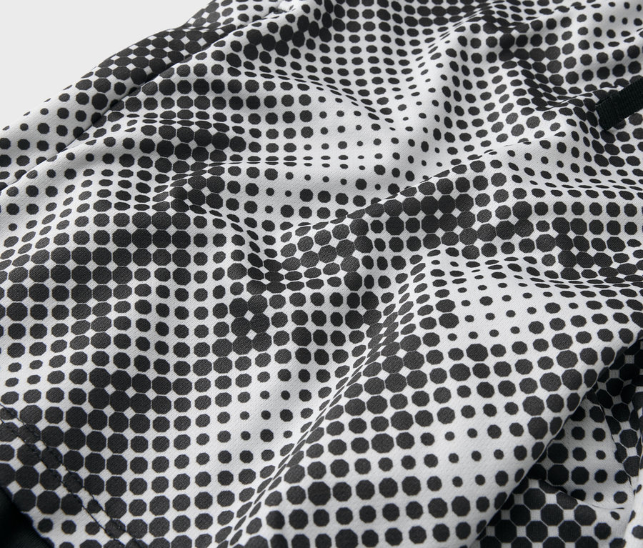 Gros plan d'un tissu avec un motif de points noirs sur fond blanc.