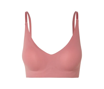Gros plan d'un soutien-gorge rose à col en V avec bretelles réglables.