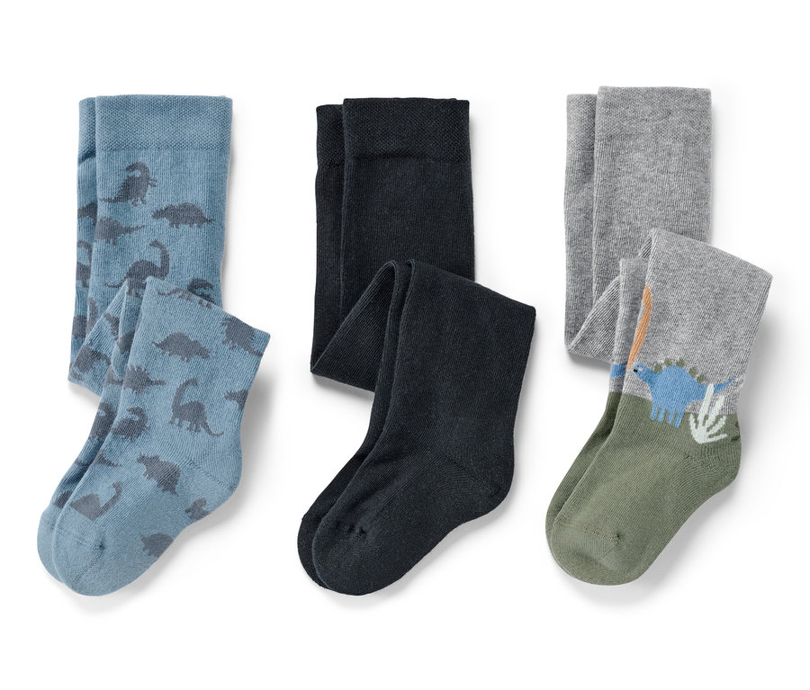 Trois paires de collants pour bébé : bleu avec des dinosaures, noir et gris avec un motif de dinosaure.