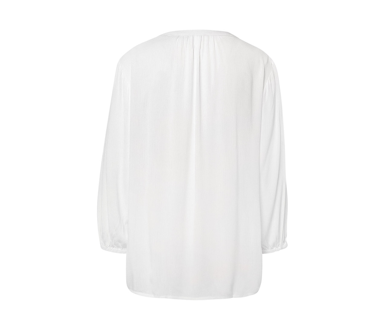 Détail d'un chemisier-tunique blanc.