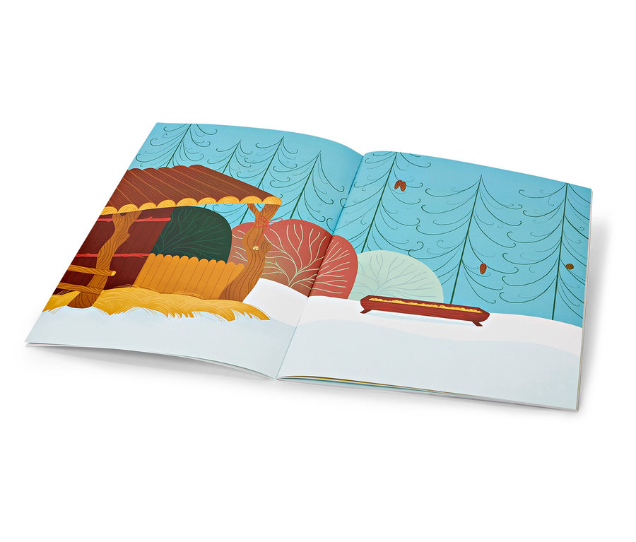 Livre ouvert illustrant un paysage hivernal avec une petite maison au premier plan.