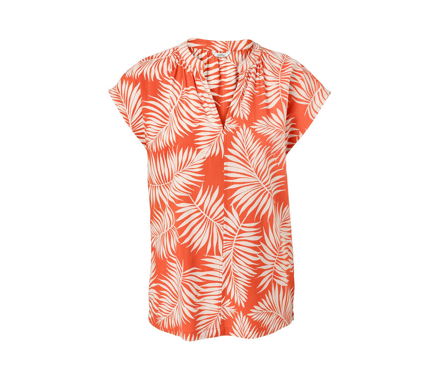 Chemisier imprimé orange à manches courtes avec motif de feuilles.