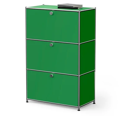 Armoire verte avec trois tiroirs et un livre dessus.
