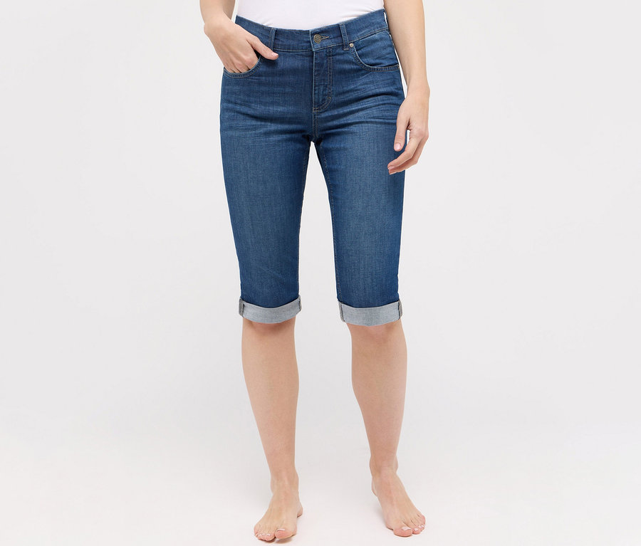 Personne portant un jean «Capri Turn-Up» Angels, coupe étroite, bleu moyen.