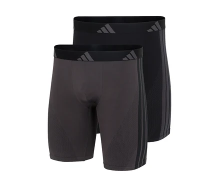 Deux boxers longs adidas Active Seamless en gris foncé et noir, avec logo adidas sur la ceinture et trois bandes sur le côté.
