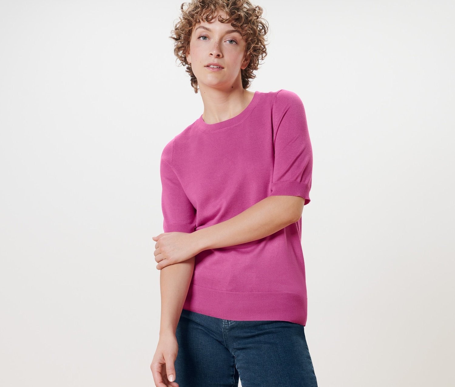 Femme posant en pull en maille fine.