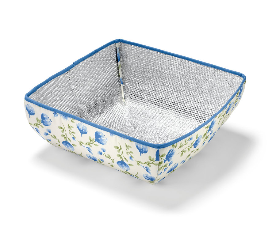 Couverture isotherme avec intérieur argenté et fleurs bleues.