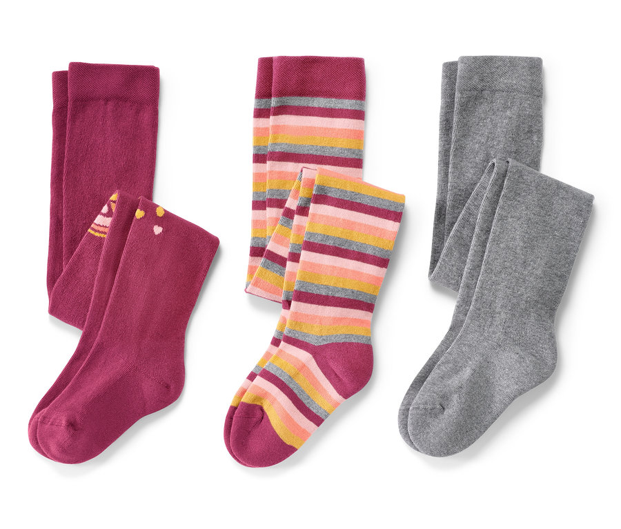 Trois paires de collants pour enfant, rose, sur fond blanc.