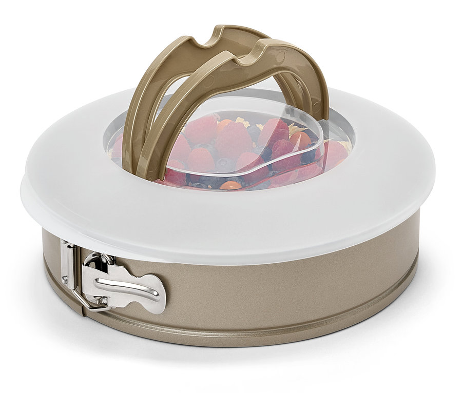 Un moule à charnière avec des fruits, un couvercle et des poignées.