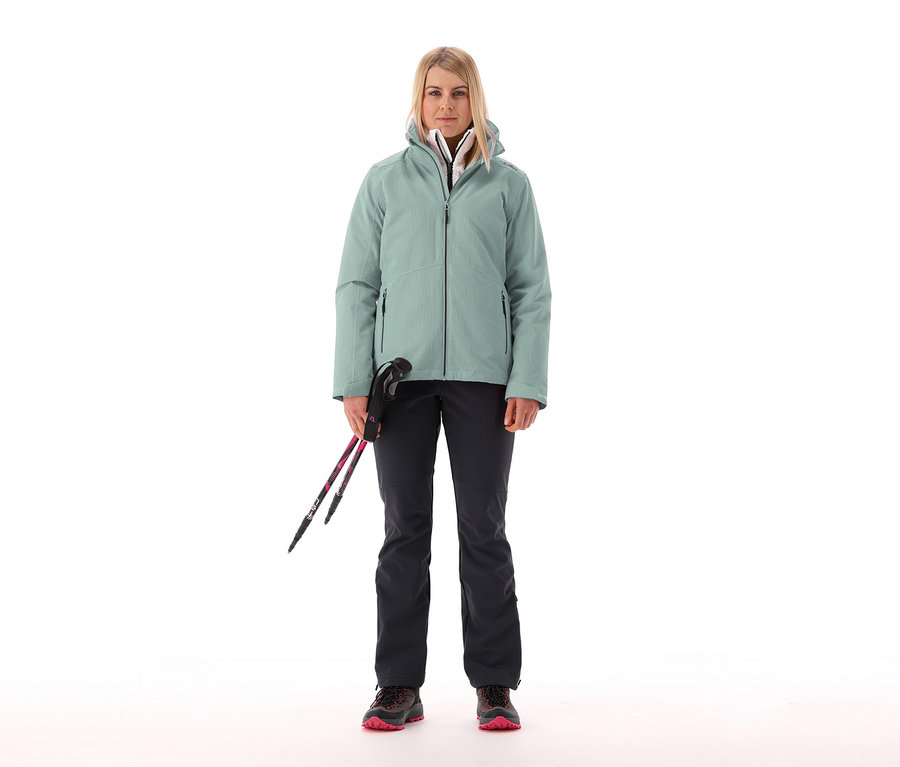 Femme tenant des bâtons de ski et portant une veste CMP pour femmes avec gilet polaire amovible.