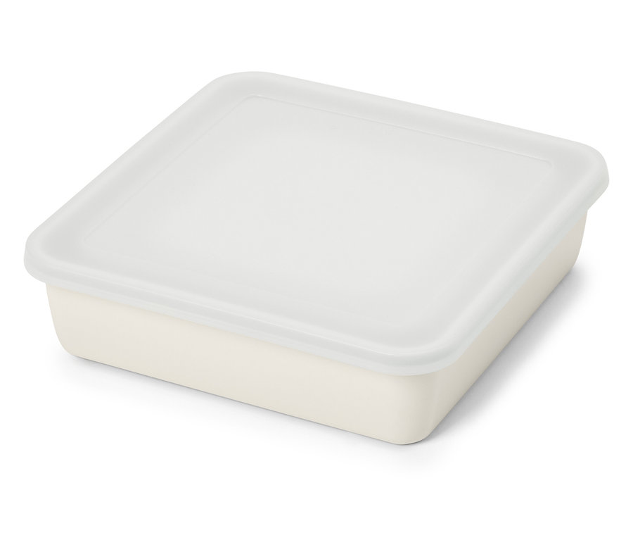 Boîte de conservation beige rectangulaire avec couvercle transparent posée sur une surface blanche.