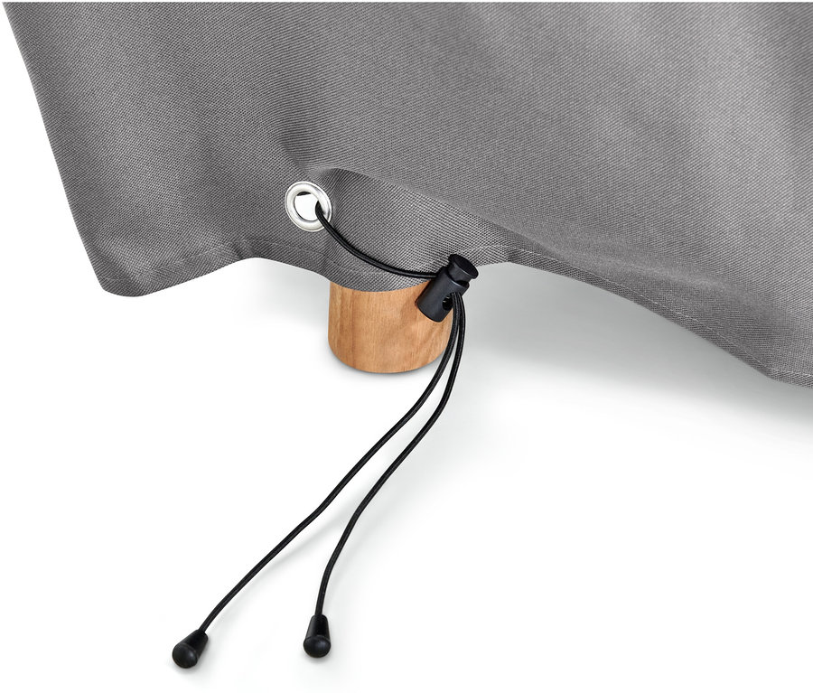 Détail d'une housse premium grise pour grandes tables à rallonge avec cordon de serrage noir et un pied de table en bois.