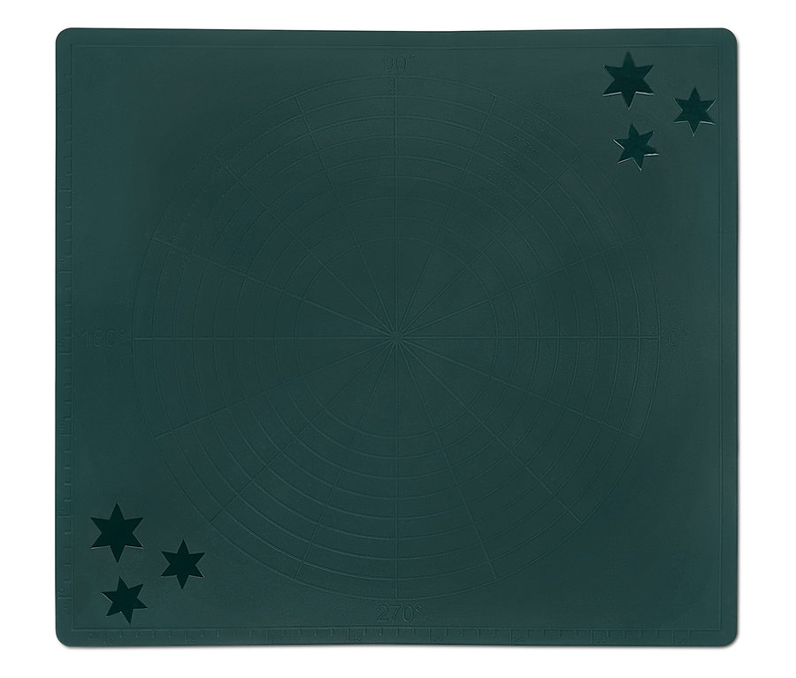 Tapis de découpe vert avec graduation et étoiles dans les coins.