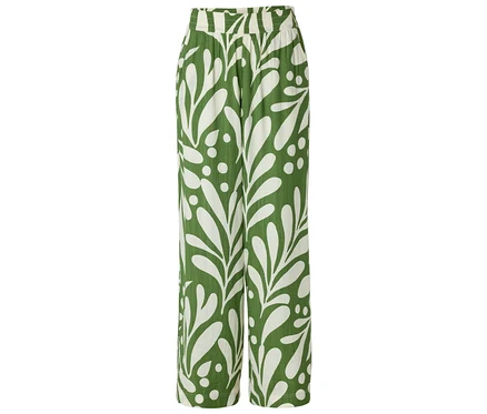 Pantalon vert avec motif de feuilles blanches.
