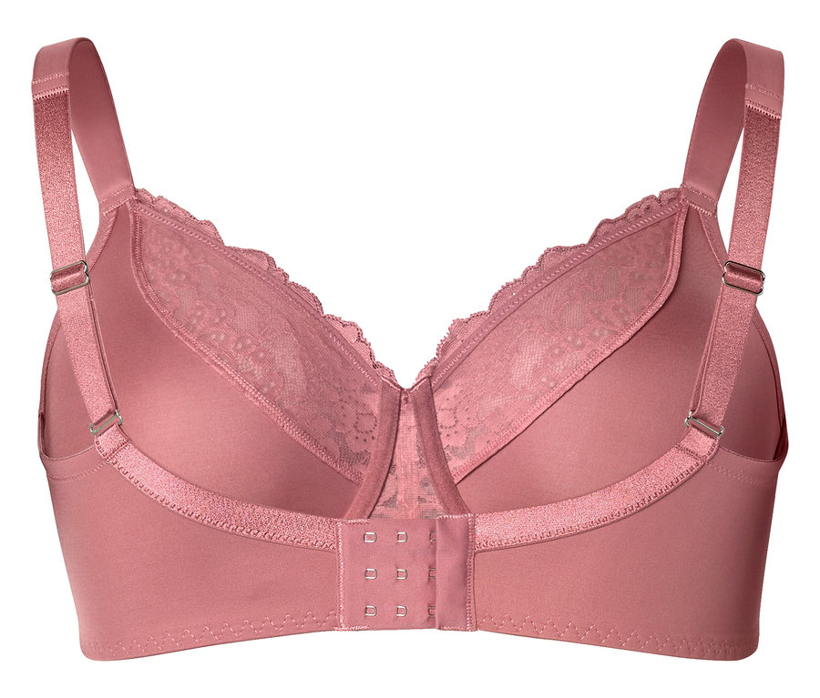 Gros plan d'un soutien-gorge rose avec de la dentelle et des bretelles réglables.