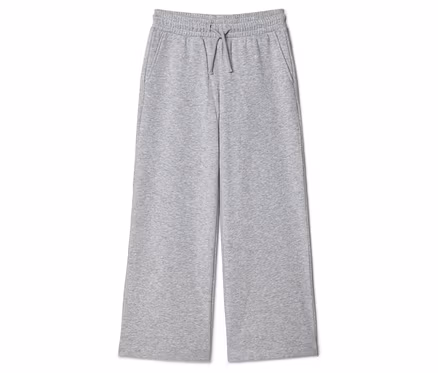 Pantalon de survêtement gris large avec cordon de serrage et poches, posé sur fond blanc.