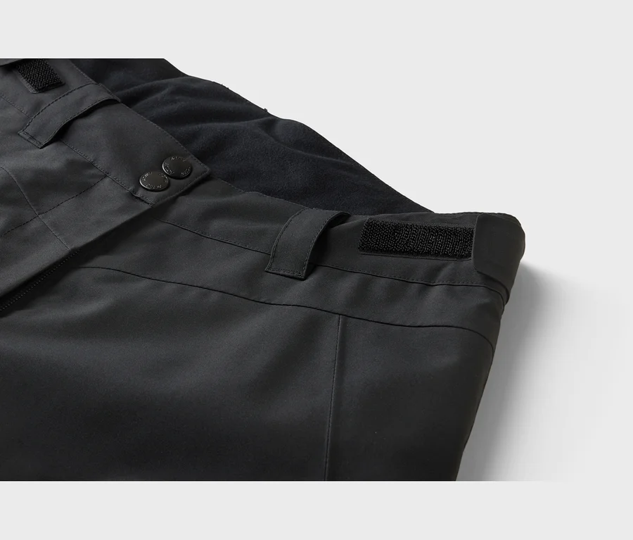Pantalon noir avec boutons-pression, fermeture éclair, réglage de la taille par velcro et doublure en polaire.